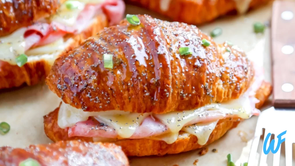 Ham and cheese croissant with a side of fruit